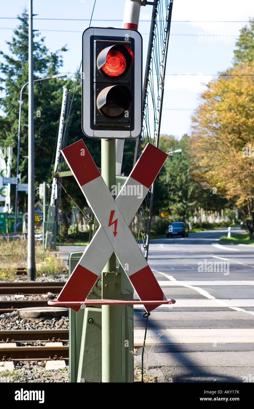 St Andrew`s Cross with red traffic light and opened gates, Hessen, Germany Stock Photo